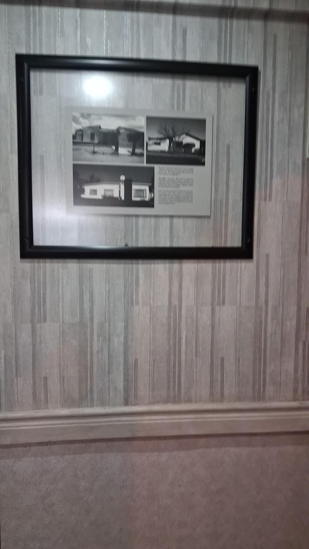 Framed heritage wall art in the guest hallway
