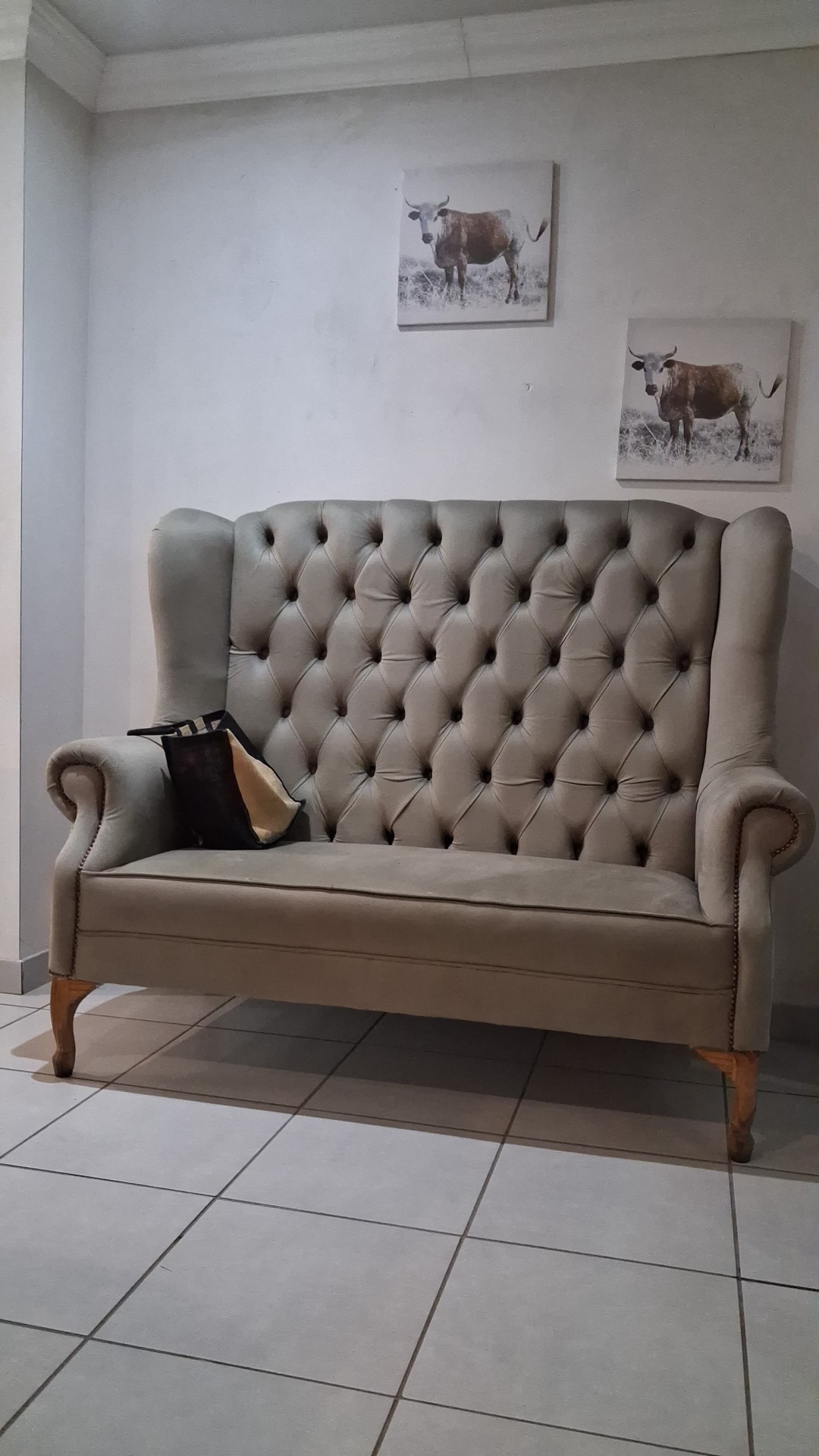 Grey tufted wingback lounge sofa in the hallway lounge area