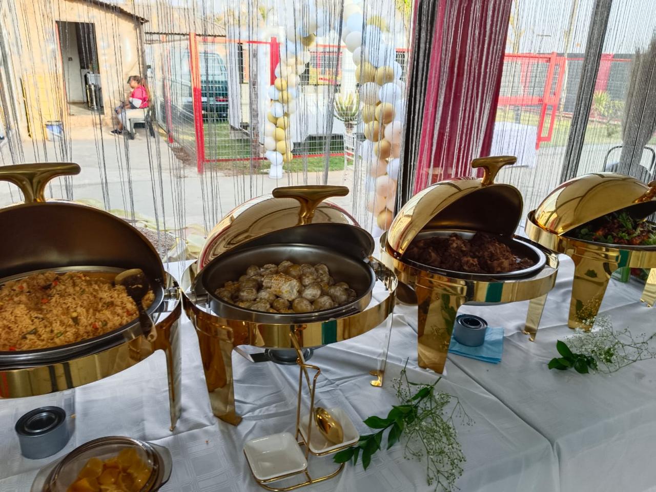 Golden chafing dishes with fried rice, potatoes and meats