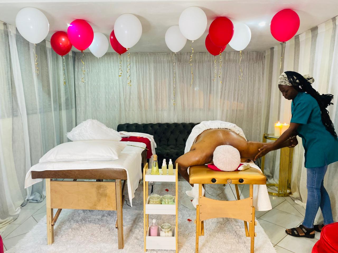 Couples spa suite with balloons and candlelit massage in progress