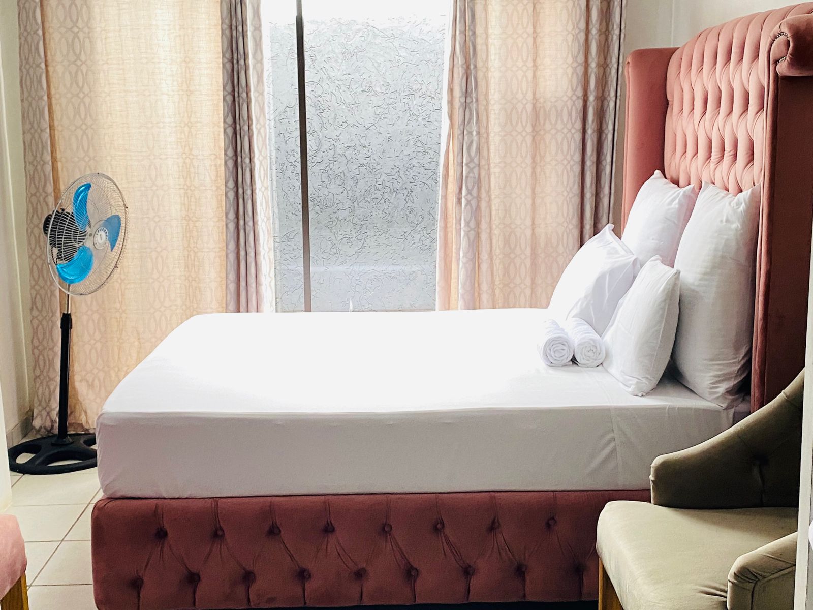 Pink chesterfield tufted headboard with crisp linen