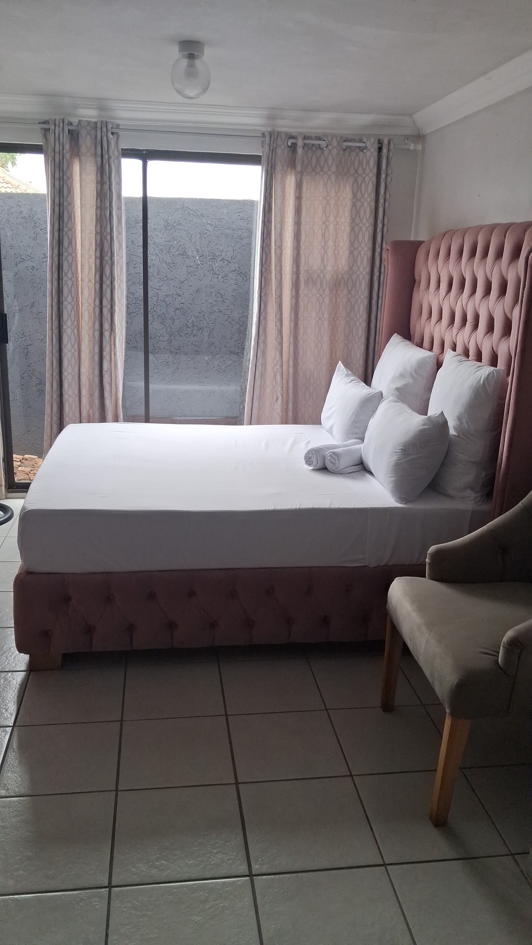Pink tufted headboard bedroom with sliding door